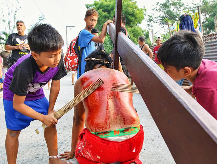 Magdarame devotees relive Christ's passion by carrying heavy crosses and flagellating themselves in San Fernando, Pampanga, during the Maleldo 2019, Holy Week Philippines, photo by Ivan Kralj