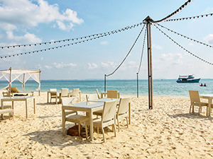 Beach restaurant at Mooban Talay Resort, tables set in the sand of Ao Noi Na beach, Koh Samet island, Thailand, photo by Ivan Kralj