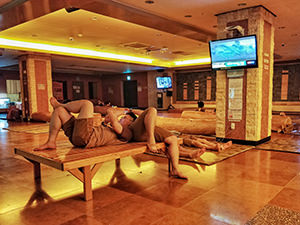 Young men relaxing in Dodu Waterpark, Korean spa / jjimjilbang on Jeju island, South Korea, photo by Ivan Kralj