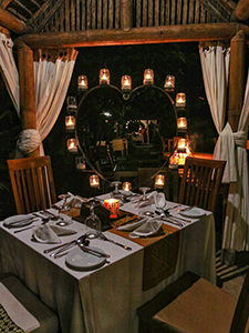 Dinner set with candles forming the shape of heart under the gazebo in Munduku Moding Plantation, nature resort in Bali, Indonesia, photo by Ivan Kralj