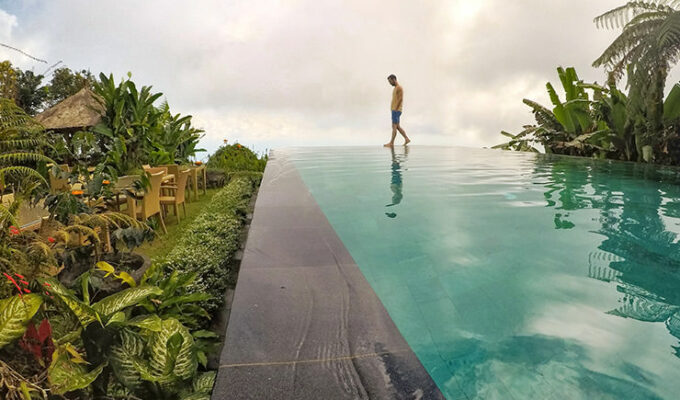 Pipeaway blogger Ivan Kralj walking on the edge of the infinity pool at Munduk Moding Plantation, the only resort set on the working coffee plantation in Bali, Indonesia, photo by Ivan Kralj