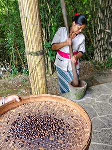 Kadek, one of the farmers working at Munduk Moding Plantation, grinds roasted coffee in a traditional way, Bali, Indonesia, photo by Ivan Kralj