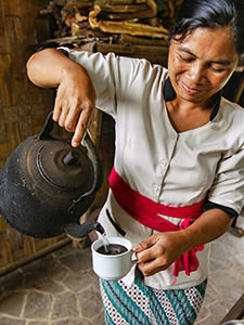 Kadek, one of the farmers on Munduk Moding Plantation, pours coffee into a cup for the visitor of the resort, Bali, Indonesia, photo by Ivan Kralj