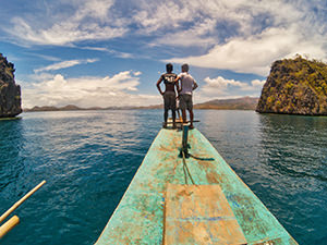 Okoy crew standing on the forecastle of bangka, a boat serving Coron Island Tour in Palawan, Philippines, photo by Ivan Kralj