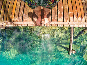 Human standing on the boardwalk next to Kayangan Lake on Coron Island, Palawan, Philippines, photo by Ivan Kralj