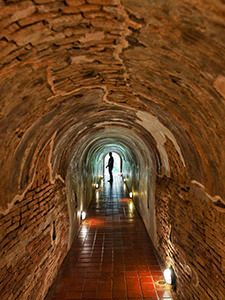 A man standing in one of the meditation tunnels in Wat U-Mong, a must-see temple in Chiang Mai, Thailand, photo by Ivan Kralj