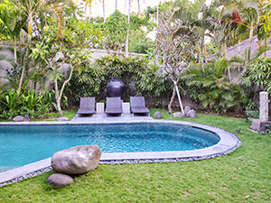 Sun loungers and tropical vegetation around the pool at the villa in The Amala Estate, one of the best hotels in Bali, Indonesia, photo by Ivan Kralj