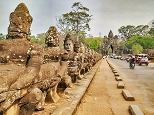 Sculptures of devas pulling the snake with asuras, and producing the Churning of the ocean of milk, on the bridge to Angkor Thom, one of great historical Khmer cities, photo by Ivan Kralj