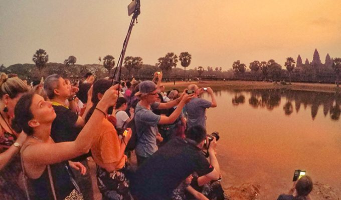 Angkor Wat sunrise draws many visitors to the most famous Cambodian temple, they gather early with all their photo equipment on the crowded reflection pond, photo by Ivan Kralj