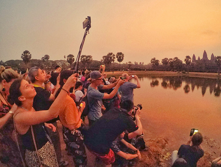 Angkor Wat sunrise draws many visitors to the most famous Cambodian temple, they gather early with all their photo equipment on the crowded reflection pond, photo by Ivan Kralj