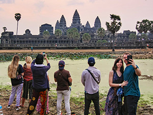 Tourists taking a selfie in front of Angkor Wat and the pond filled with conferva, photo by Ivan Kralj