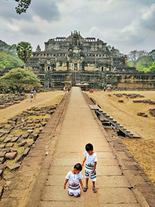 Children dressed in Angkor Wat shirts in front of Bapuon pyramid in Angkor Thom, Cambodia, photo by Ivan Kralj