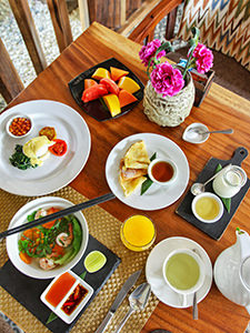 Khmer noodle soup with shrimps, poached eggs, pancakes, tropical fruit, yogurt with honey, juice and tea served for breakfast at Heritage Suites Hotel, a five-star hotel in Siem Reap, Cambodia, photo by Ivan Kralj