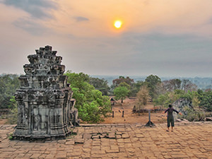 A woman doing the Sun salutation on the top of Phnom Bakheng, the state temple of Yasodharapura, the first Angkor capital, photo by Ivan Kralj