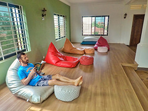 Pipeaway blogger Ivan Kralj reading a book about Angkor Wat, while sitting on the bean bag in Sleep Pod Hostel in Siem Reap, Cambodia, photo by Ivan Kralj