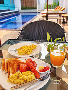 Continental breakfast with scrambled eggs and sausage, served by the pool in Sleep Pod Hostel in Siem Reap, Cambodia, photo by Ivan Kralj