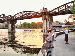 People taking selfies in front of the Bridge on The River Kwai, a part of the infamous Death Railway from the Second World War in Kanchanaburi, Thailand, photo by Ivan Kralj