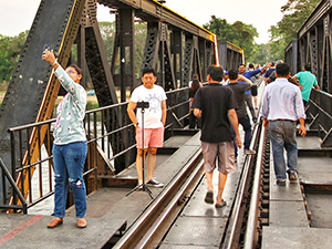 People taking selfies on the Bridge on The River Kwai, a part of the infamous Death Railway from the Second World War in Kanchanaburi, Thailand, photo by Ivan Kralj