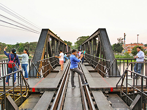 People taking selfies on the Bridge on The River Kwai, a part of the infamous Death Railway from the Second World War in Kanchanaburi, Thailand, photo by Ivan Kralj