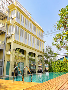 Outdoor swimming pool in the yard of the yellow building of Latima Boutique Hostel in Kanchanaburi, Thailand, photo by Ivan Kralj