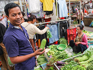 Chef Men Somera picking vegetables at the local market he wll use for cooking in The Balé Phnom Penh resort, Cambodia, photo by Ivan Kralj