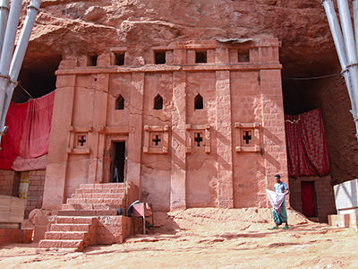 Priest in Bet Danaghel Church holding the Cross of King Lalibela. The  rock-hewn churches of Lalibela make it one of the greatest  Religio-Historical sites not only in Africa but in the Christian