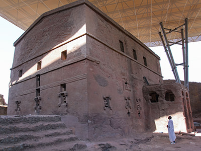 Priest in Bet Danaghel Church holding the Cross of King Lalibela. The  rock-hewn churches of Lalibela make it one of the greatest  Religio-Historical sites not only in Africa but in the Christian