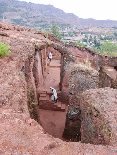 Priest in Bet Danaghel Church holding the Cross of King Lalibela. The  rock-hewn churches of Lalibela make it one of the greatest  Religio-Historical sites not only in Africa but in the Christian