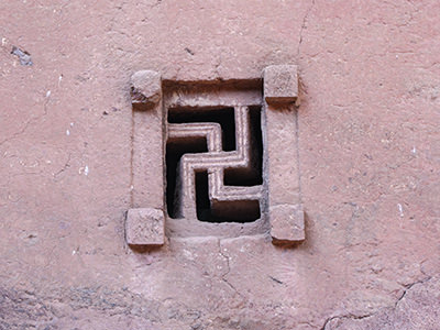 Swastika-shaped carved-out window at Bete Maryam, Lalibela church, Ethiopia, photo by Ivan Kralj