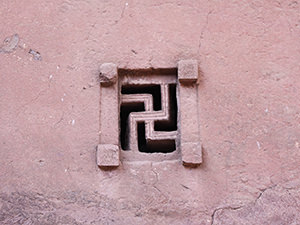 Swastika-shaped carved-out window at Bete Maryam, Lalibela church, Ethiopia, photo by Ivan Kralj