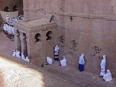 Men and women praying, each at their own side, in the exterior of Bete Maryam church in Lalibela, Ethiopia, photo by Ivan Kralj