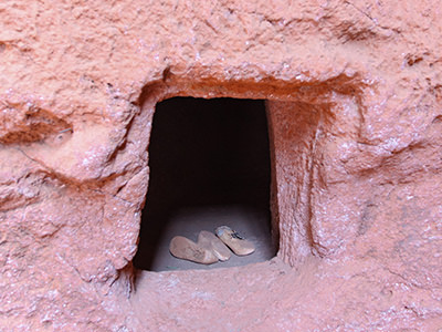 One of the holes in the wall surrounding Lalibela churches, where some pilgrims come to live, some to die. Lalibela, Ethiopia. Photo by Ivan Kralj