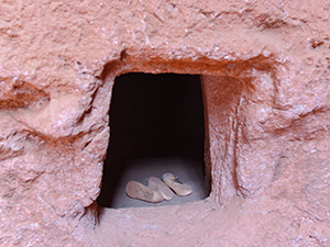 One of the holes in the wall surrounding Lalibela churches, where some pilgrims come to live, some to die. Lalibela, Ethiopia. Photo by Ivan Kralj