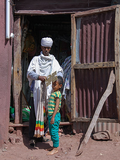 A priest blessing a boy with a healing cross in Lalibela, Ethiopia. Photo by Ivan Kralj