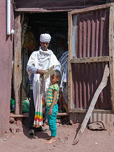 A priest blessing a boy with a healing cross in Lalibela, Ethiopia. Photo by Ivan Kralj