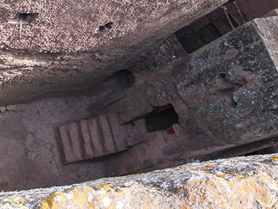 Priest in Bet Danaghel Church holding the Cross of King Lalibela. The  rock-hewn churches of Lalibela make it one of the greatest  Religio-Historical sites not only in Africa but in the Christian