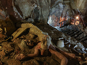 A sculpture of a crocodile swallowing a human victim in Am Phu Cave, the Buddhist representation of Hell in the Marble Mountains, Vietnam, photo by Ivan Kralj