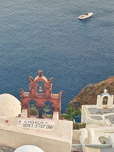 "Don't step on" sign on one of the churches in Oia, Santorini, where tourists used to flock in great numbers to experience Santorini sunset, Greece, photo by Ivan Kralj