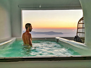 Ivan Kralj in the plunge pool of You & Me Suites in Firostefani, Santorini, Greece, photo by Nikos Samartzis