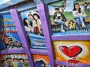 Colorful murals inside of the Indonesian Chicken Church fighting against various forms of addictions, such as cigarettes, drugs or technological devices, photo by Ivan Kralj 