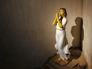 A statue of a woman praying in the underground chambers of Gereje Ayam, the Indonesian Chicken Church in Central Java, photo by Ivan Kralj