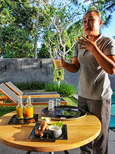 Ibu Balik, the massage therapist at Aria Villas Ubud, presenting jamu, the traditional medicine drinks of Indonesia, photo by Ivan Kralj