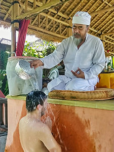 A priest in Ubud performing melukat, the traditional Hindu purification ritual where he spills water over the individual, Bali, Indonesia, photo by Ivan Kralj