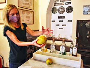 Staff at Vallindras distillery showing how big should the 2 kilo Kitro citrus be, Chalkio, Naxos, Greece, photo by Ivan Kralj