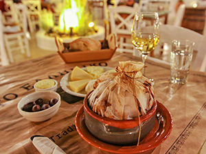 Kleftiko and selection of Naxos cheeses on the table of To Elliniko, one of the best restaurants to eat at in Naxos, Greece, photo by Ivan Kralj