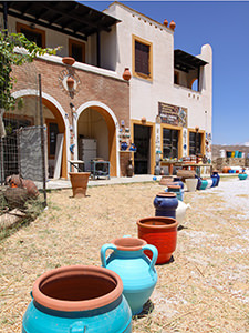 Colorful pots displayed in front of the Limpertas Manolis pottery workshop in Damalas, Naxos Island, Greece, photo by Ivan Kralj