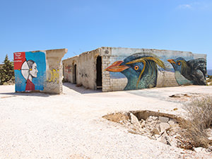 Street art on the walls of the abandoned hotel in Alyko; visiting this place is one of the most unusual things to do in Naxos, Greece, photo by Ivan Kralj