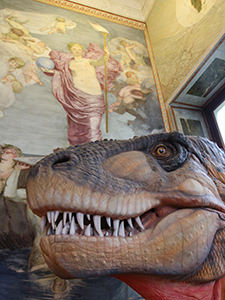 Dinosaur head in front of a fine art painting, as displayed at the Museum of Natural History in Basel, Switzerland, photo by Ivan Kralj