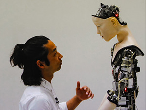 Japanese dancer Mirai Moriyama talking to the robot Alter animated by artificial intelligence, in the video installation "Co(AI)xistence" by Justine Emard, presented at House of Electronic Arts, one of the best museums in Basel, Switzerland, photo by Ivan Kralj