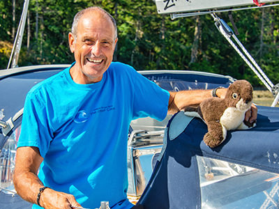 Bert terHart posing with a plush seal toy he sailed around the world with